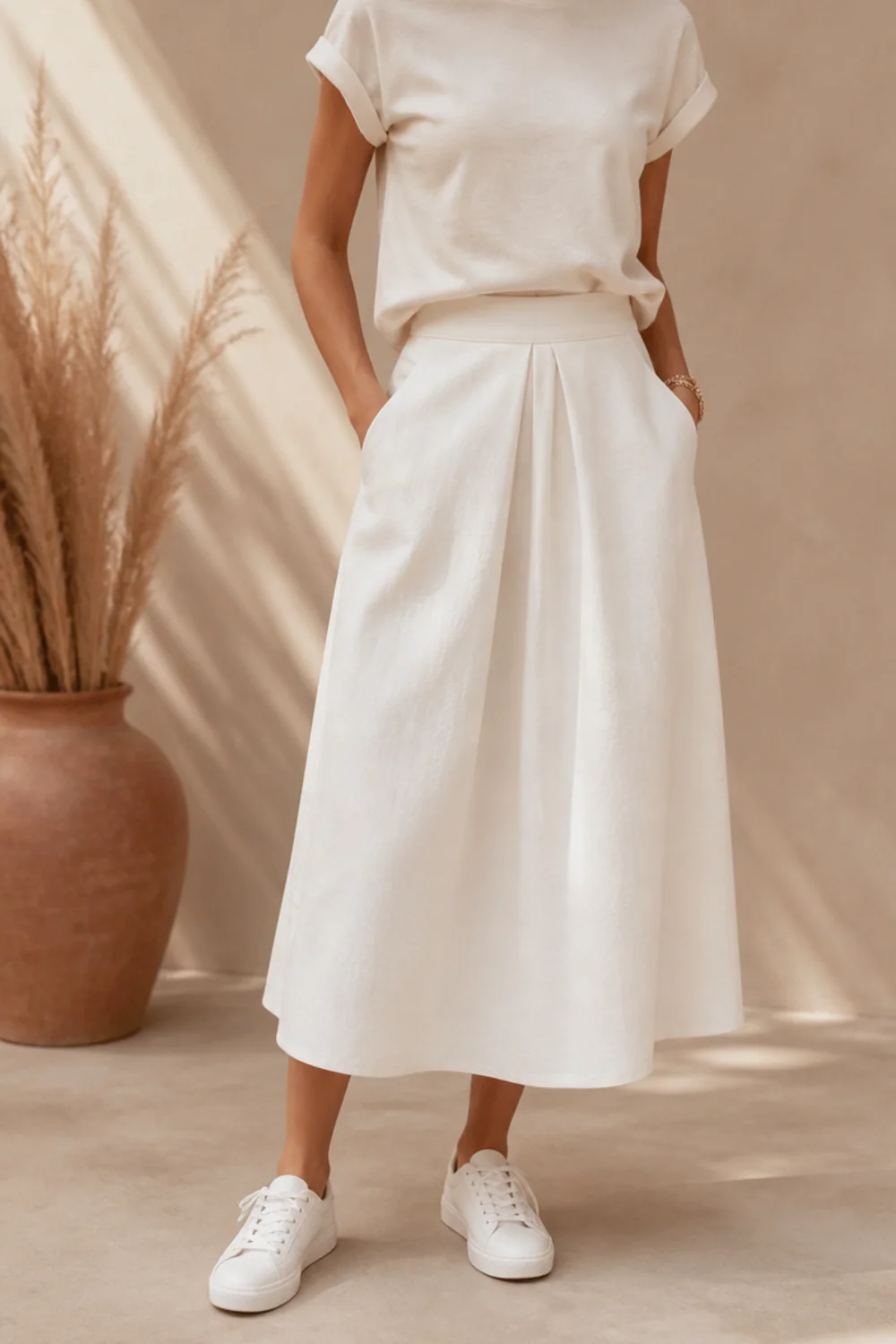 Faceless white skirt and sneakers outfit with a tee and white trainers